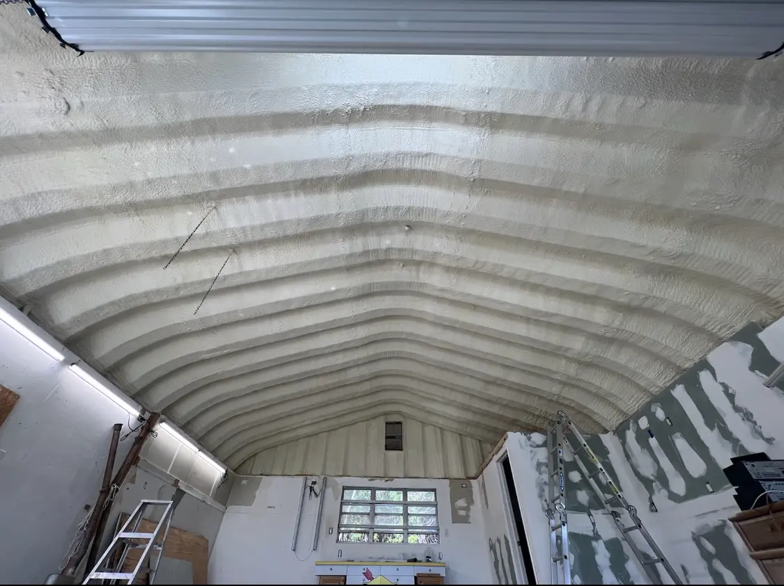 Spray polyurethane foam applied to the underside of a metal roof deck in Yoakum